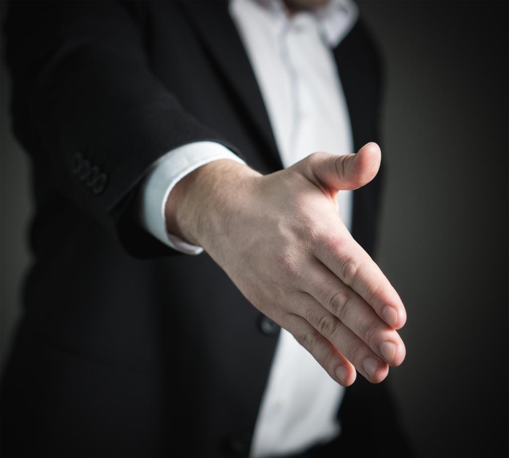 A close-up handshake representing communication, repair and apology., Therapist guiding Individual Counseling with a reflective client in Cherry Creek - CO during a focused session